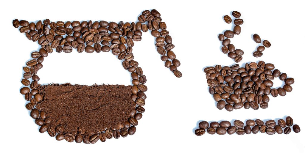 coffee beans arranged to make the shapes of a coffee pot and cup of coffee
